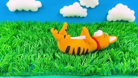 A playful claymation cat joyfully rolling in a v